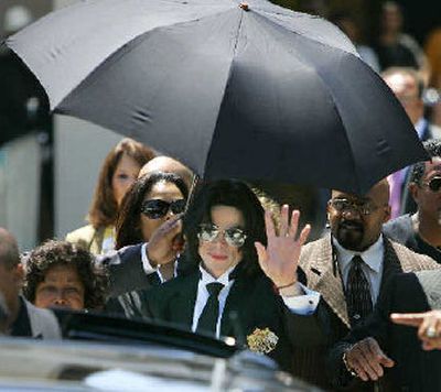 
Michael Jackson, center, is joined by his mother, Katherine, left, as he leaves the courthouse in Santa Maria, Calif., on Monday. 
 (Associated Press / The Spokesman-Review)