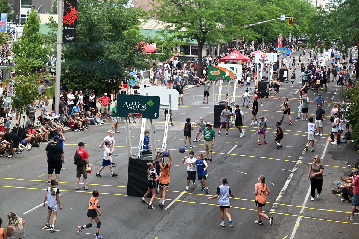 Youth players and crowds of spectators fill West Main Avenue for the first day of Hoopfest 2024 on Saturday. (Jesse Tinsley/THE SPOKESMAN-REVIEW)