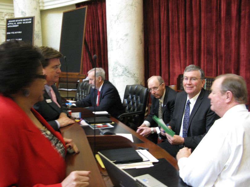 House Speaker Scott Bedke, second from right, visits with senators in the Senate chamber on Wednesday evening (Betsy Russell)