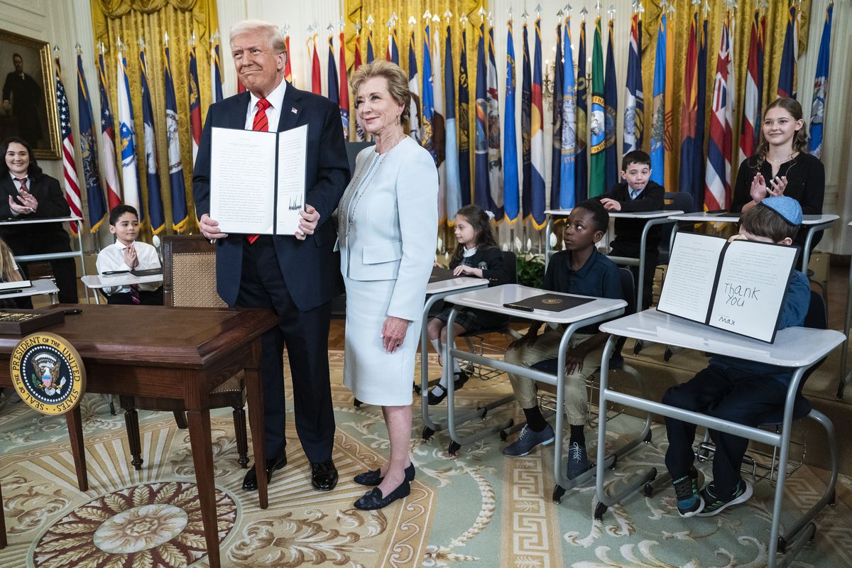 President Donald Trump with Secretary of Education Linda McMahon after signing an executive order aimed at closing the Education Department in March. (Jabin Botsford/The Washington Post)