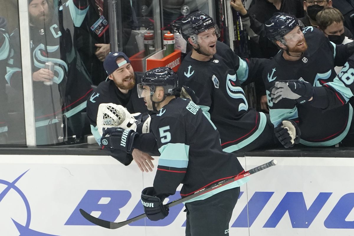 Seattle Kraken defenseman Mark Giordano (5) is congratulated after he scored a goal against the Calgary Flames during the first period of an NHL hockey game Thursday, Dec. 30, 2021, in Seattle. (Ted S. Warren)