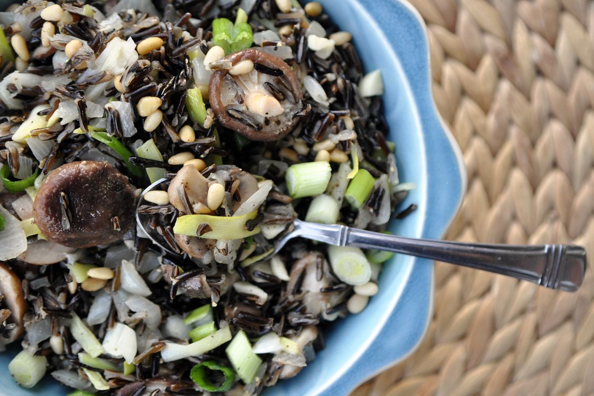 Sliced and sautéed, cattails add a pop of green to this wild rice pilaf with mushrooms. (Adriana Janovich)