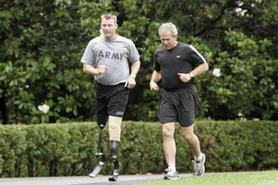 
President Bush jogs Tuesday on the South Lawn of the White House with Army Staff Sgt. Christian Bagge, 23, from Eugene, Ore. Bagge lost both his legs in a roadside bombing in Iraq. 
 (Associated Press / The Spokesman-Review)