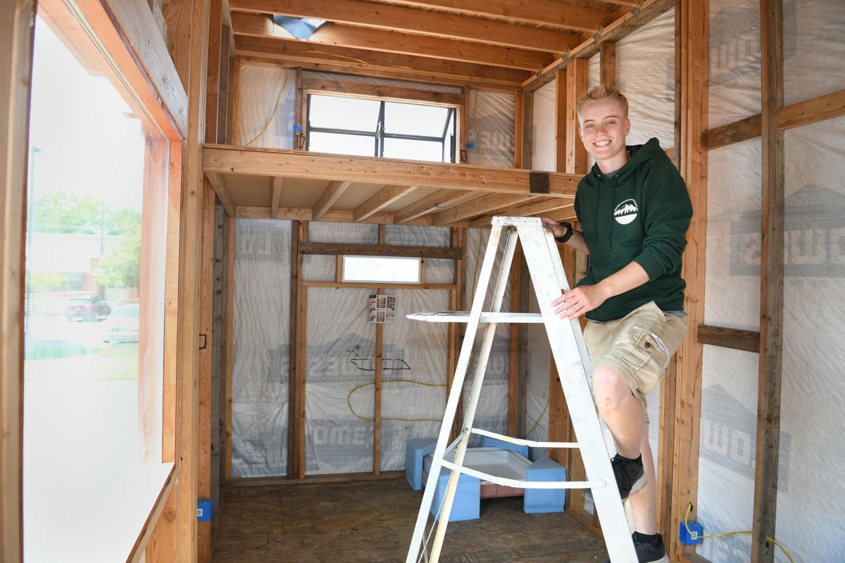 Emmett Linklater, a senior at The Community School in Spokane, stands in the partially finished tiny house he built for a project at school, shown Friday, June 8, 2018. (Jesse Tinsley / The Spokesman-Review)