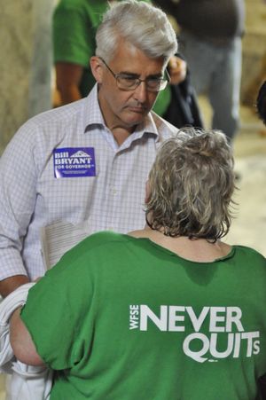 OLYMPIA -- GOP gubernatorial candidate Bill Bryant talks with state employee during a rally for higher wages and better benefits in the Capitol Rotunda.  (Jim Camden/The Spokesman-Review)