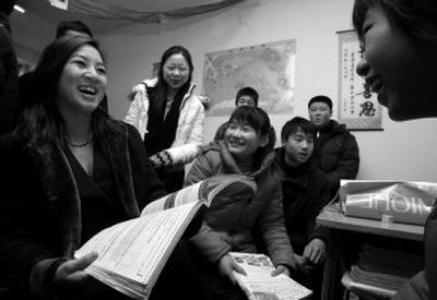  Skater Michelle Kwan, left, talks to students Thursday  in Beijing  while on a visit as  an American 