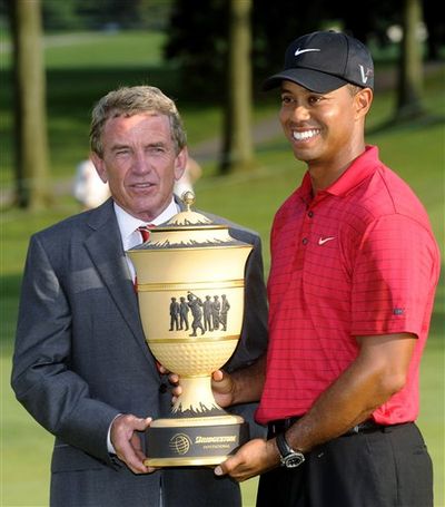 Tiger Woods, right, holds the trophy with PGA Tour commissioner Tim Finchem after Woods won the Bridgestone Invitational golf tournament Sunday, Aug. 9, 2009, at Firestone Country Club in Akron, Ohio.  (Phil Long / Associated Press)