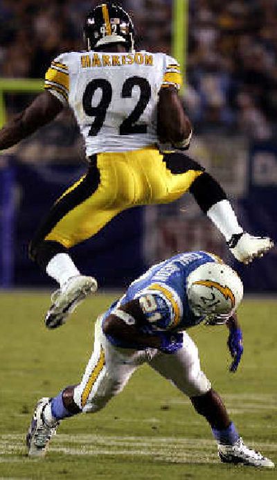 
Steelers linebacker James Harrison hurdles LaDainian Tomlinson. 
 (Associated Press / The Spokesman-Review)