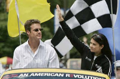 
Indy Racing League driver Danica Patrick, right, waves to the crowd during the 500 Festival Parade in Indianapolis on Saturday. The 89th running of the Indianapolis 500 is today. Riding with Patrick is Paul Hospenthal.
 (Associated Press / The Spokesman-Review)