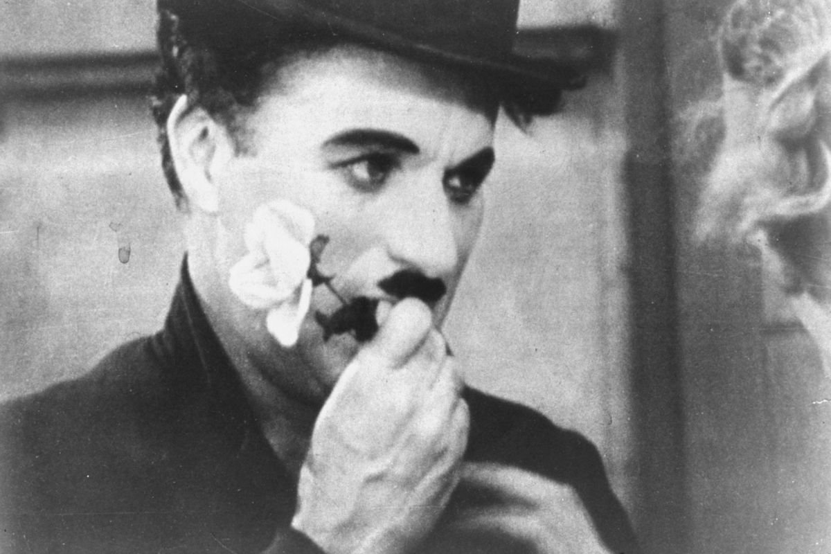 Charlie Chaplin holds a rose in this photo from the final scene in his 1931 silent film “City Lights.” (AP)