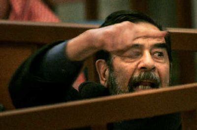 
Saddam Hussein shouts out from his seat in the courtroom as the latest session of his trial begins Monday in Baghdad, Iraq. 
 (Associated Press / The Spokesman-Review)
