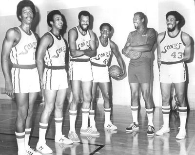 A group of Seattle veterans laughed at a wisecrack by their new coach, Bill Russell, during the Sonics’ picture day before the 1973-74 season. From left are Joby Wright, Bud Stallworth, Jim McDaniels, John Brisker, Russell and Kennedy McIntosh.  (Ron De Rosa/Seattle Times)