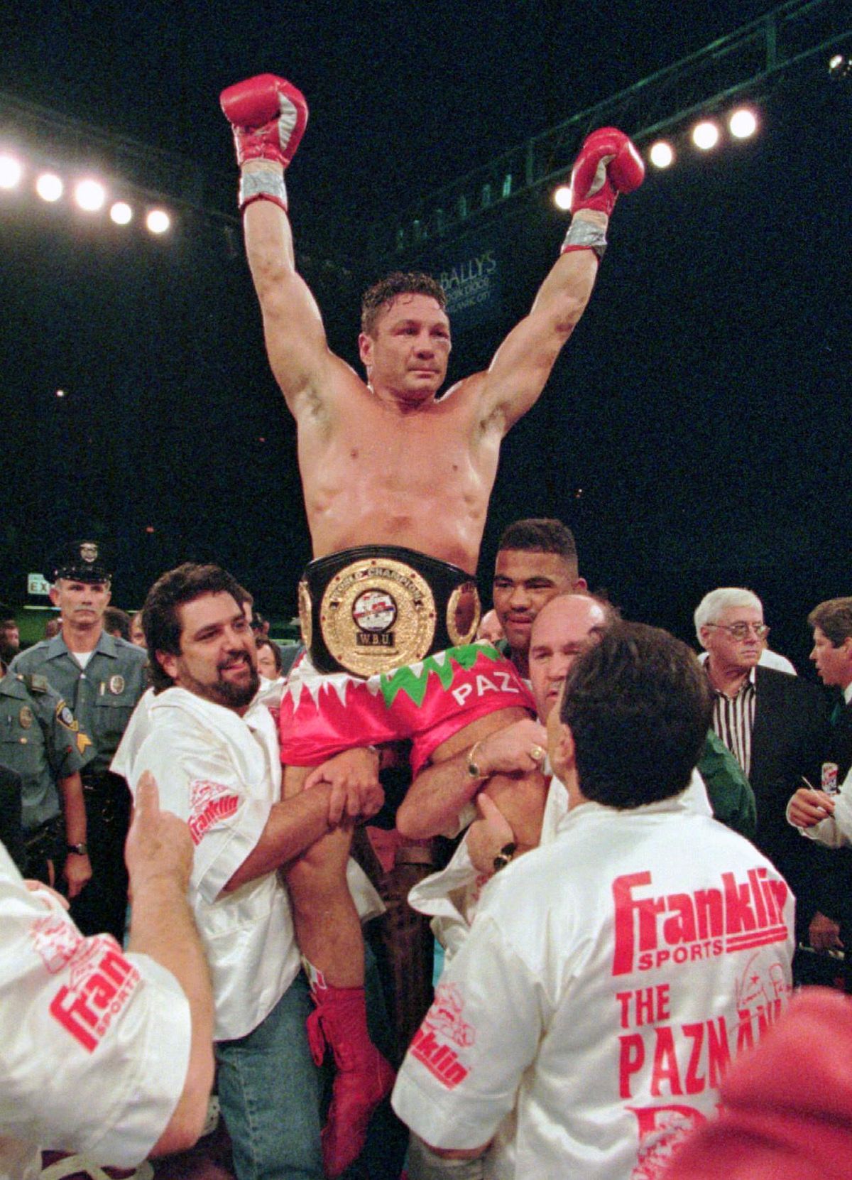 In this Aug. 23, 1996 file photo, boxer Vinny Paz, of Providence, R.I., is lifted up after winning a 12-round WBU super middleweight title bout against Dana Rosenblatt in Atlantic City, N.J. A new film, “Bleed For This,” based on Pazienza’s life, opened Friday. (BILL BORRELLI / Associated Press)