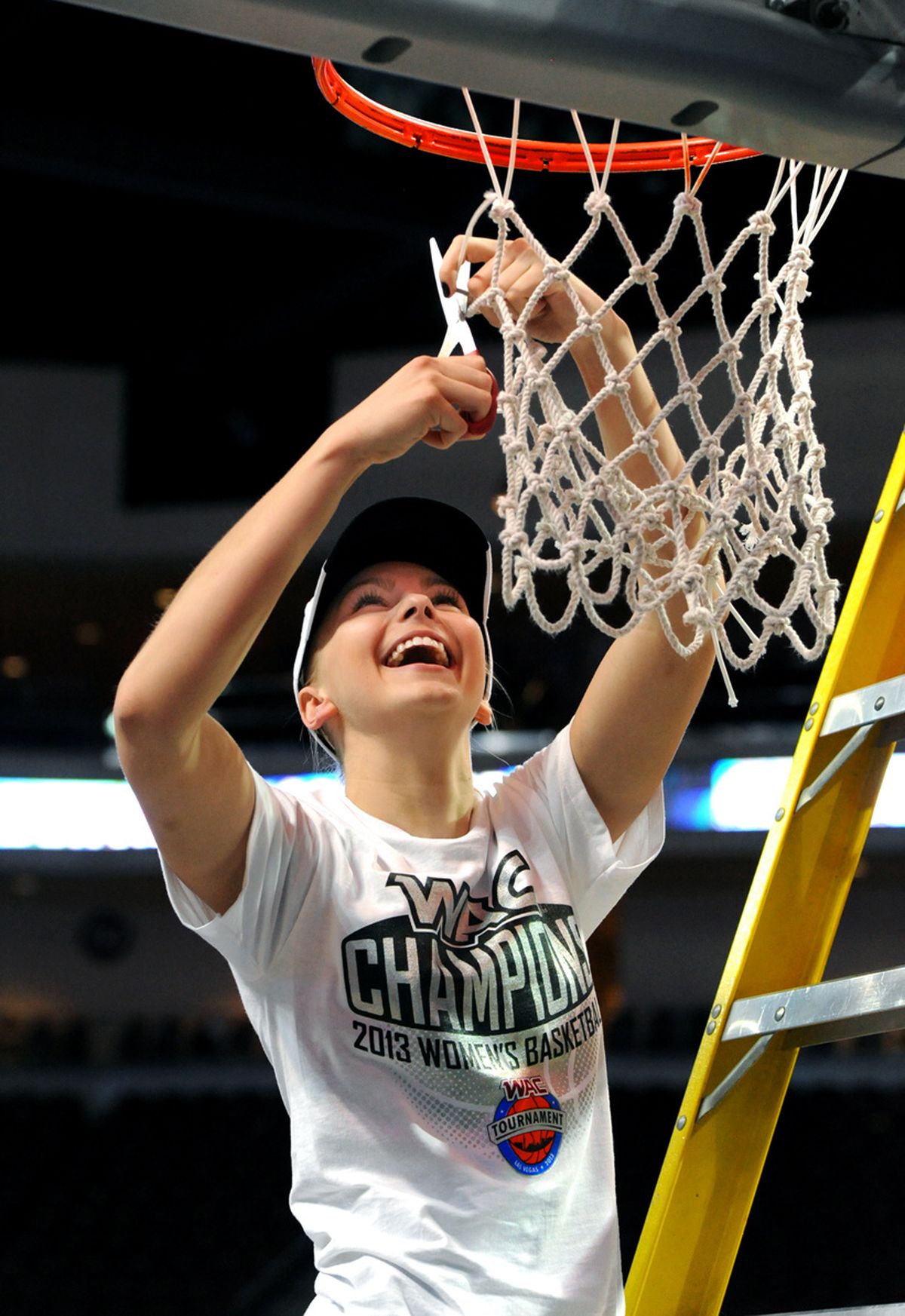 Idaho’s Alyssa Charlston takes her turn cutting down a piece of the net following victory. (Associated Press)