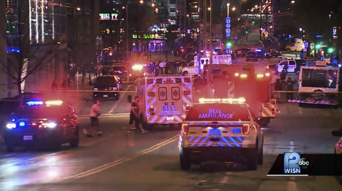 This photo taken from video provided by WISN 12 News shows police responding to the scene of a shooting at Water Street and Juneau Avenue in Milwaukee, Friday, May 13, 2022. Twenty people were injured in two shootings in downtown Milwaukee near an entertainment district where thousands of people were watching the Bucks play the Celtics in the NBA