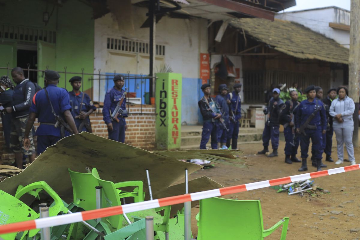 An area is cordoned off as police officers inspect the scene of a bomb explosion in Beni, eastern Congo Sunday Dec. 26, 2021. A bomb exploded at a restaurant Saturday as patrons gathered on Christmas Day in an eastern Congolese town where Islamic extremists are known to be active.  (Al-hadji Kudra Maliro)