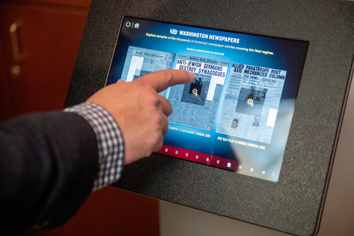 Among the displays filled with photos and text are touchable interfaces to look at newspapers from the World War II era.  (Jesse Tinsley/THE SPOKESMAN-REVIEW)