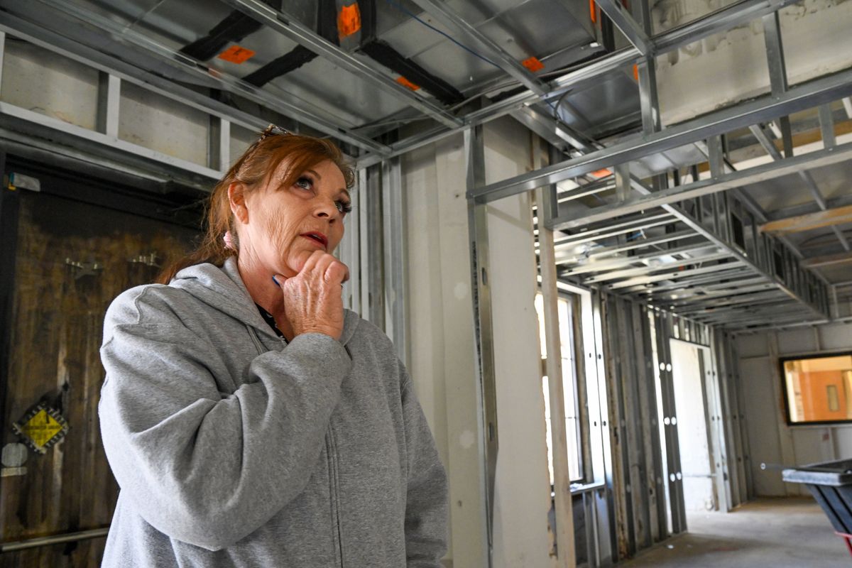 Sandra Melter, owner of the Skyway Cafe, looks around the interior of the restaurant at Felts Field on Wednesday in Spokane. The restaurant was heavily damaged in a fire last January. (Jesse Tinsley/THE SPOKESMAN-REVIEW)