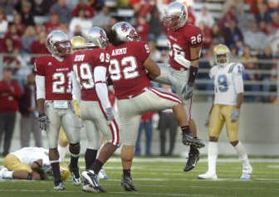 Washington State free safety Xavier Hicks (26) celebrates a hard hit that knocked UCLA wide receiver Brandon Breazell, on the ground, out of Saturday's game at Martin Stadium.
(Christopher Anderson / The Spokesman-Review)