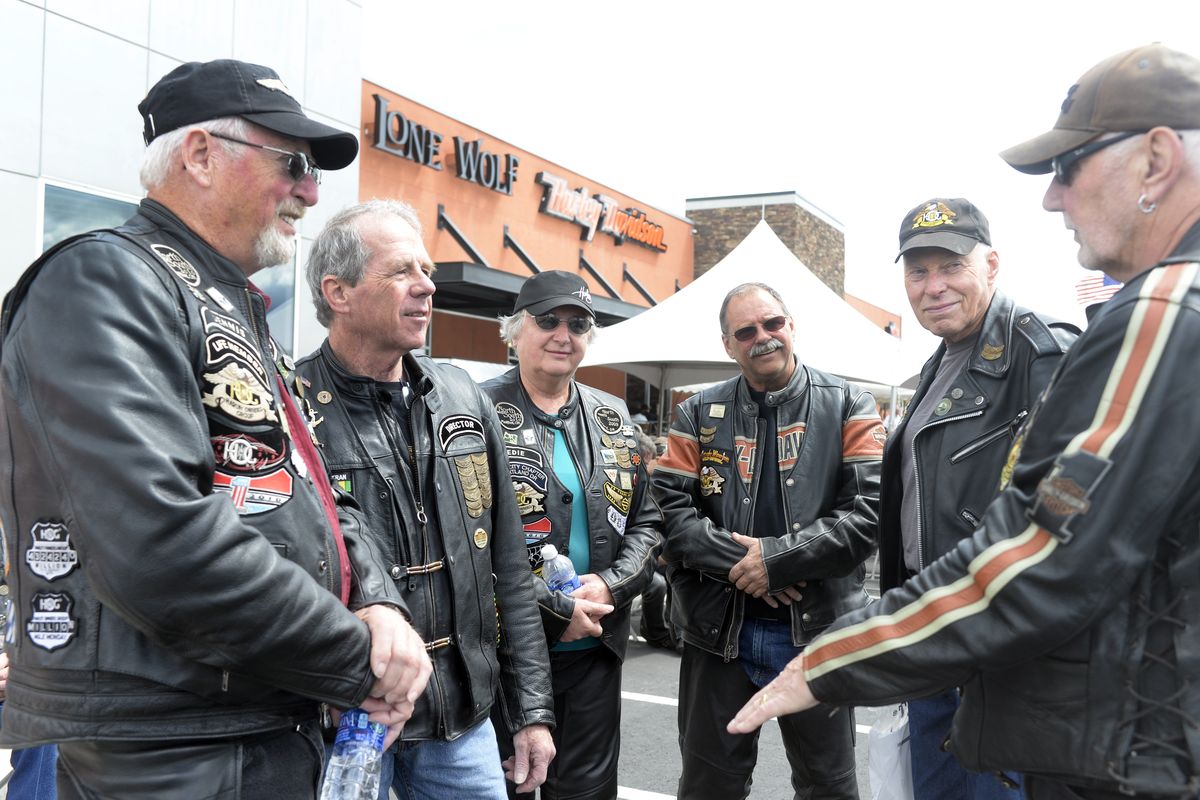 Oregon riders, from left, Dennis Fisk, John Clark, Edie Fisk, Tom Marshall, Bob Sahleen and Bill Joy chat Thursday outside the Harley-Davidson dealership in Spokane Valley. Joy is 76 and says that riding his Harley keeps him young. (Jesse Tinsley)