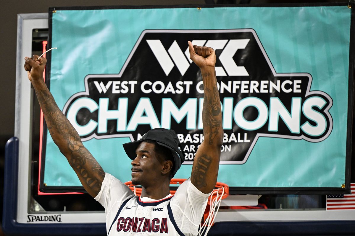 Gonzaga Bulldogs guard Tyon Grant-Foster (7) lifts a piece of the game net to GU fans after Gonzaga defeated the Portland Pilots during the second half of a college basketball game to secure the WCC regular season title on Wednesday, Feb 25, 2026, at McCarthey Athletic Center in Spokane, Wash. Gonzaga won the game 89-48.  (Tyler Tjomsland/The Spokesman-Review)
