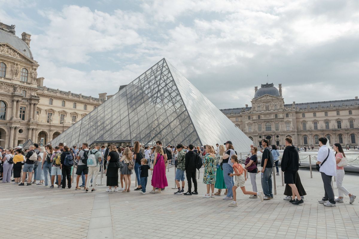 Visitors line up to enter the Louvre in Paris on Sept. 14, 2023.  (New York Times)