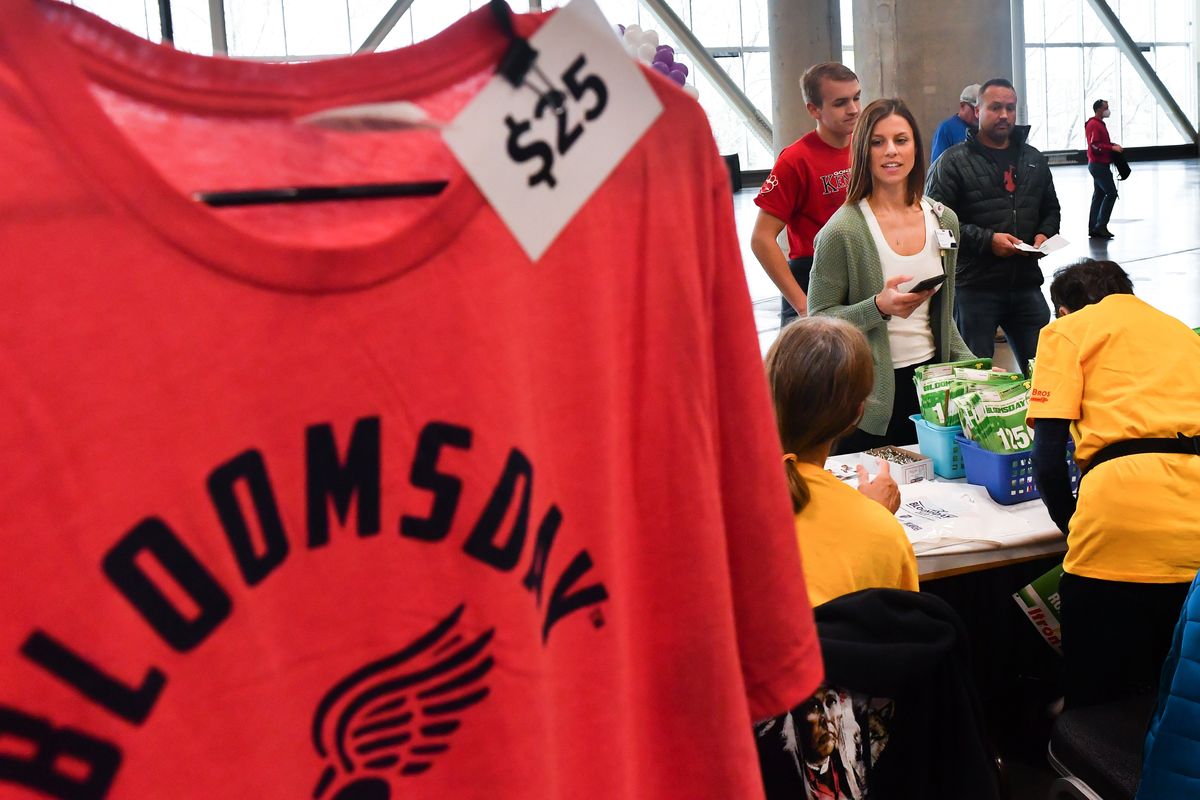 Lauren Hopkins, of Spokane smiles as she picks up her Bloomsday packet at the Bloomsday Trade Show on Friday, Apr 29, 2022, at the Spokane Convention Center in Spokane, Wash.  (Tyler Tjomsland/The Spokesman-Review)
