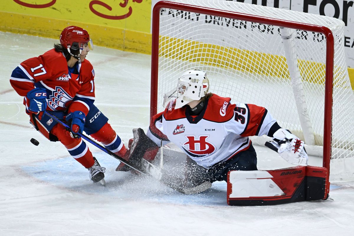 Lethbridge goaltender Harrison Meneghin (35) deflects a puck as Spokane forward Carter Streek (17) cut into the ice during a WHL hockey game, Saturday, Dec. 3, 2022, in the Spokane Veterans Memorial Arena.  (Colin Mulvany/The Spokesman-Review)