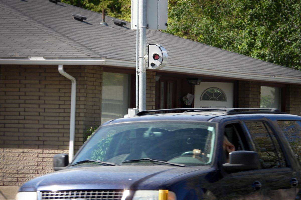 The camera portion of a speed camera system hangs on a post next to North Nevada Street, a block north of Longfellow Elementary School, shown Thursday, May 13, 2021. The camera enforcement system was placed there to slow cars when students are coming and going from Longfellow.  (Jesse Tinsley/The Spokesman-Review)