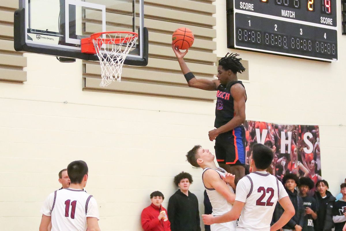 Mt. Spokane forward Maverick Sanders draws a charge against Rainier Beach in a State 3A opening-round game Saturday at West Valley.  (Cheryl Nichols/For The Spokesman-Review)