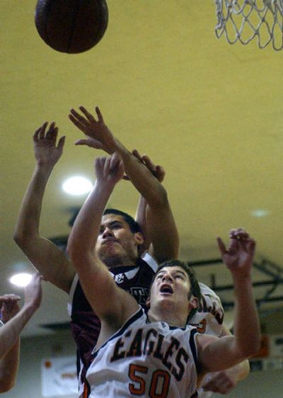 
Ryan Town of the West Valley, front, works to block North Central's Nick Rijon from a rebound during Friday's game at WV. 
 (Brian Plonka / The Spokesman-Review)