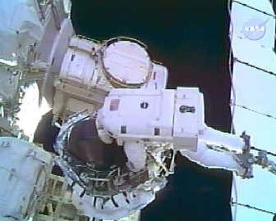 
Astronaut Dave Williams rides on the end of the robotic arm to install a new gyroscope on the International Space Station during a spacewalk Monday. The image is from NASA television.Associated Press
 (Associated Press / The Spokesman-Review)