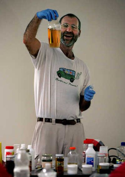 
Lyle Rudensey, of Seattle, displays biodiesel made from oil during a class he taught at Everett Community College. Associated Press
 (Associated Press / The Spokesman-Review)