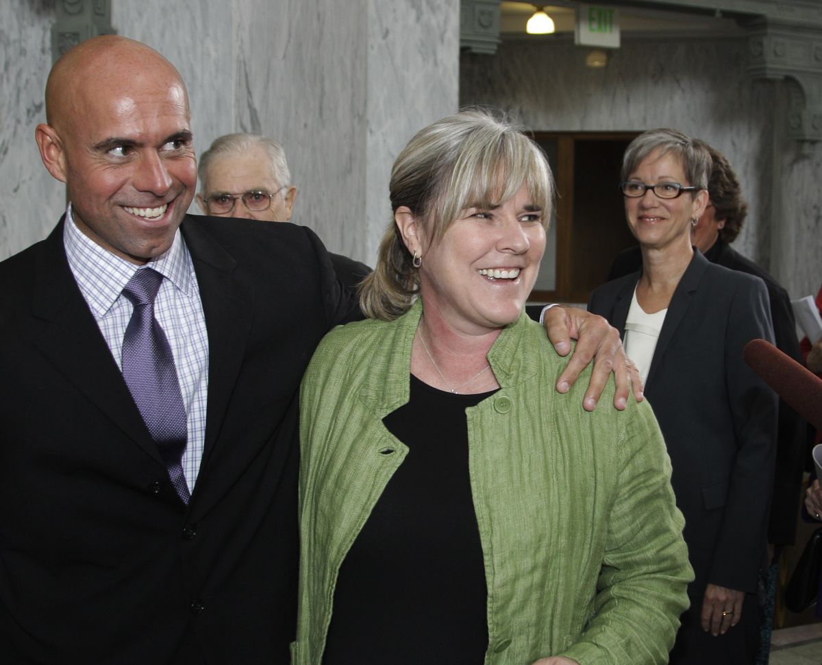 Margaret Witt, center, stands with Air Force Lt. Col. Victor Fehrenbach, left, at the federal courthouse in Tacoma, Wash., Friday, Sept. 24, 2010. A federal judge ruled Friday that Witt, a flight nurse discharged from the Air Force for being gay, should be given her job back as soon as possible. Fehrenbach, who is gay, is currently fighting his own discharge from the Air Force. (Ted Warren / Associated Press)