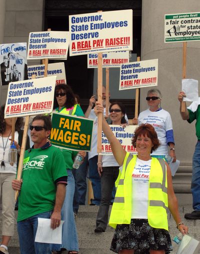 State workers rally on the steps of the Capitol on Tuesday.  (Richard Roesler / The Spokesman-Review)