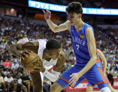 Houston’s Jabari Smith Jr. secures a loose ball while pressured by Oklahoma City’s Chet Holmgren on Saturday in Las Vegas.  (Getty Images)