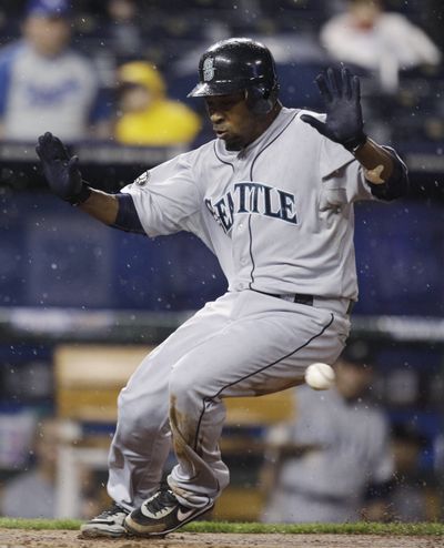 Seattle’s Chone Figgins beats the throw to home plate to score on a sacrifice fly in the eighth inning of the M’s 5-1 loss to Kansas City on Thursday. (Associated Press)