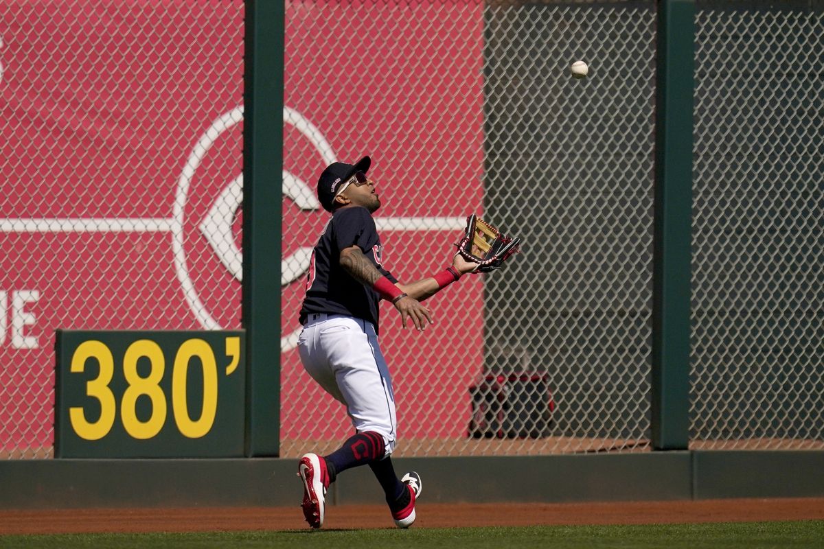 Cleveland Indians left fielder Eddie Rosario reaches out to make a catch on a fly ball hit by Los Angeles Angels
