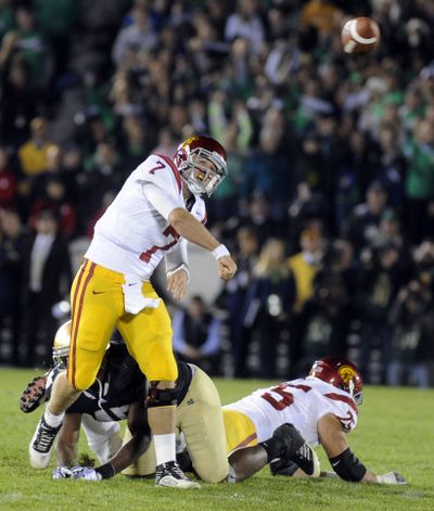 Matt Barkley completed 24 of 35 passes for 224 yards and three TDs in USC’s win. (Associated Press)