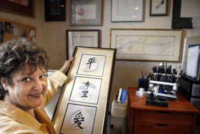 
Jan Kruger uses calligraphy in the paintings, greeting cards, journals and treasure boxes she sells from her studio.
 (Holly Pickett / The Spokesman-Review)