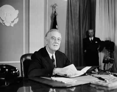 President Franklin D. Roosevelt speaks before a nationwide audience on Nov. 14, 1944, from the East Room of the White House on the eve of the Sixth War Loan campaign to urge people to buy more war bonds.  (Henry Burroughs)