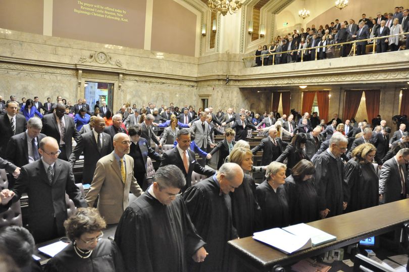 OLYMPIA -- Legislators, Supreme Court justices and the audience in the gallery join hands for a prayer to open a session to inaugurate statewide elected officials on 1/11/2017 (Jim Camden/The Spokesman-Review)