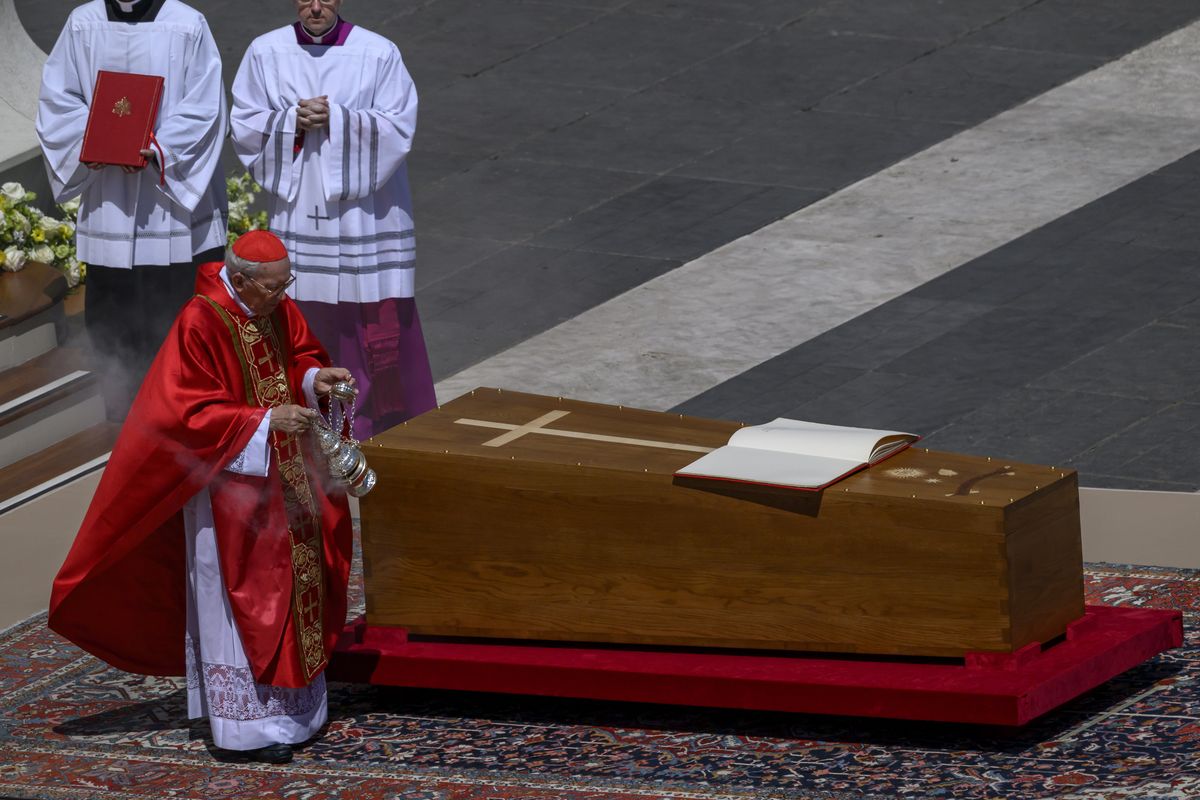 Above: Cardinal Giovanni Battista Re blesses the coffin during the funeral of Pope Francis in St. Peter’s Square on Saturday in Vatican City, Vatican. Left: U.S. President Donald Trump, center, front row, and first lady Melania Trump attend the funeral of Pope Francis in St. Peter’s Square on Saturday in Vatican City, Vatican. (Antonio Masiello)