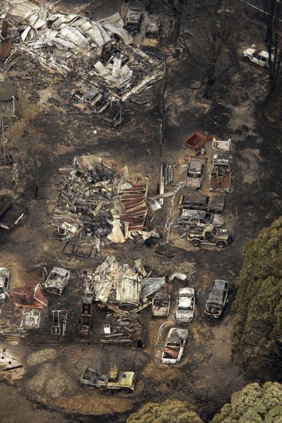 Buildings and vehicles sit destroyed at Kinglake, northeast of Melbourne, Australia, on Sunday.  (Associated Press / The Spokesman-Review)