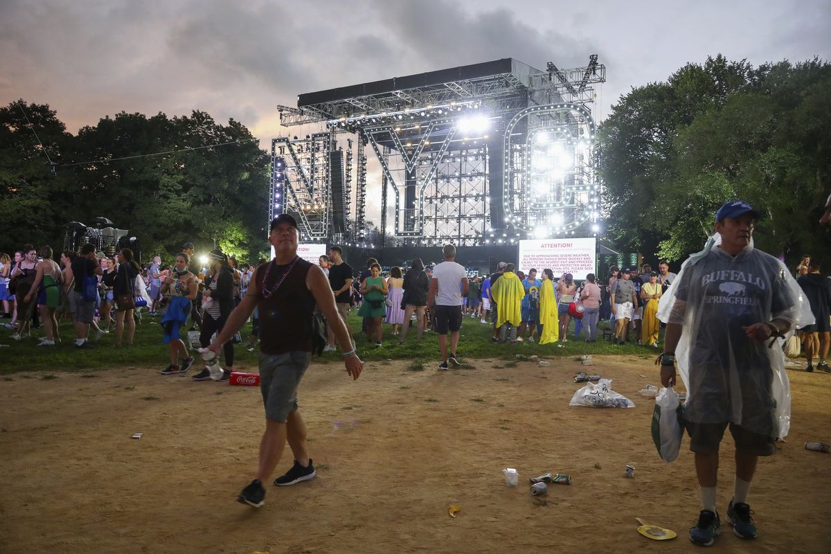Concertgoers exit the Great Lawn in Central Park after organizers cancel the "We Love NYC: The Homecoming Concert" due to approaching thunderstorms on Saturday, Aug. 21, 2021, in New York.  (Andy Kropa)