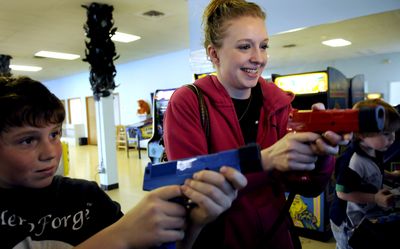 Brittany Gentile, 21,  battles 13-year-old Cody Gebel in a game of Target Terror on Tuesday at Jungle Pizza in Post Falls.  (Kathy Plonka / The Spokesman-Review)