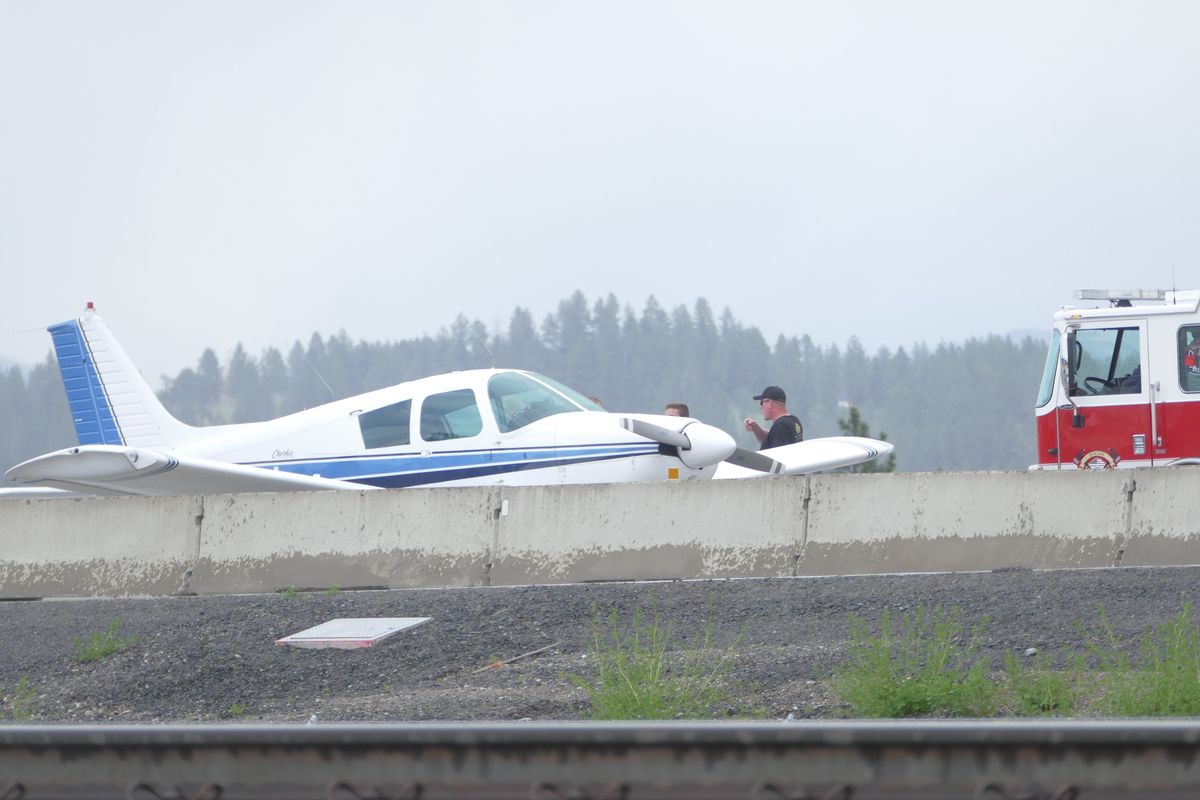 Pilots made an emergency plane landing after the plane ran out of fuel Saturday on the North Spokane Corridor in Spokane. The plane then took off from the highway when deemed safe.   (Jesse Tinsley / The Spokesman-Review)