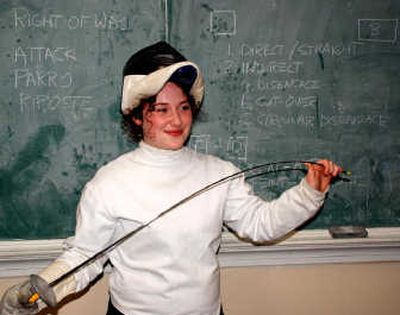 
Carolyn Travis, a 17-year-old Hayden Lake resident, flexes her foil after giving a lesson. She fenced foil and saber before suffering a knee injury in January.
 (Noah Buntain / The Spokesman-Review)