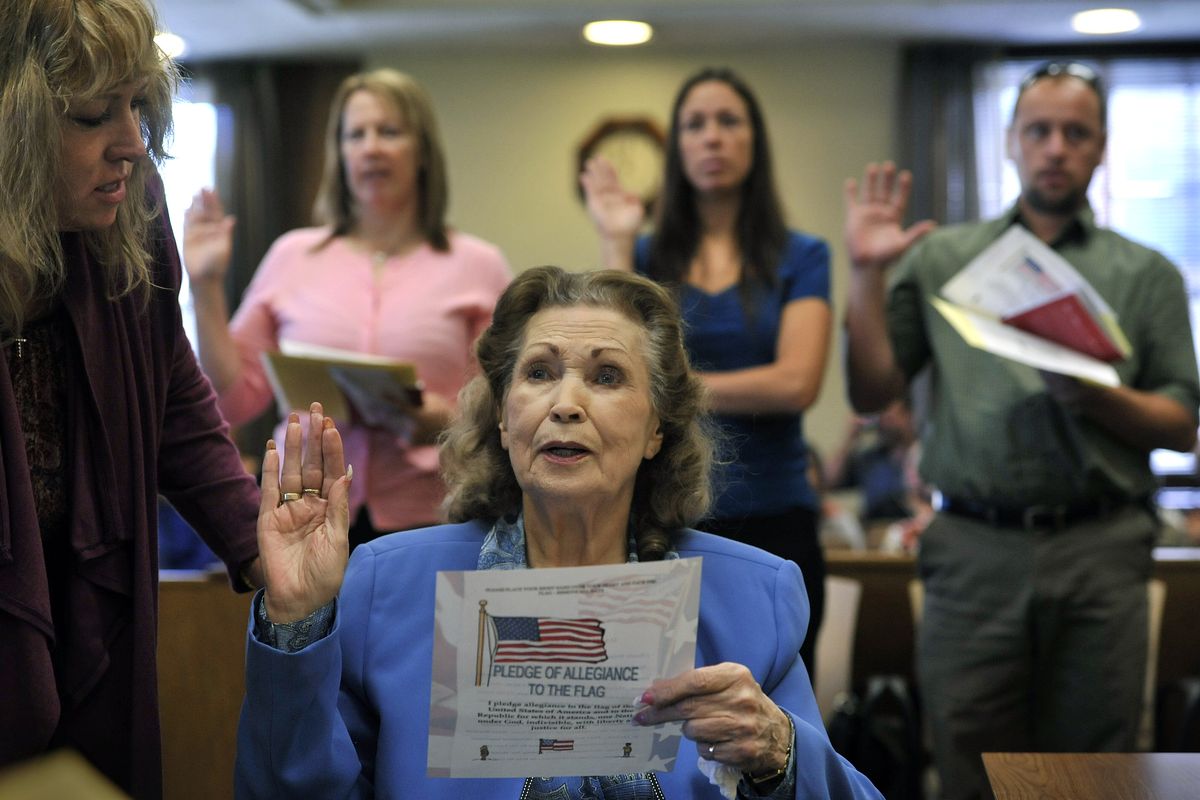 Mary Martha Surean, 86, recites the oath of citizenship Tuesday, Sept. 28, 2010, in Spokane. She is assisted by her daughter Lisa Cordier, left. Surean, originally from England, married a serviceman in the Army Air Force during World War II.  (Dan Pelle / The Spokesman-Review)