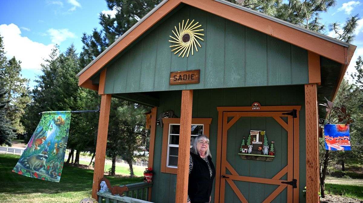 Stephanie Johnson shows off her playhouse last week. Johnson has been collecting raccoons since 1972, when she bought a 4-week-old baby raccoon from a local pet store in California. People started buying her all kinds of raccoon things. Twelve years ago, she got a she shed where she could display them. (Kathy Plonka/The Spokesman-Revie)